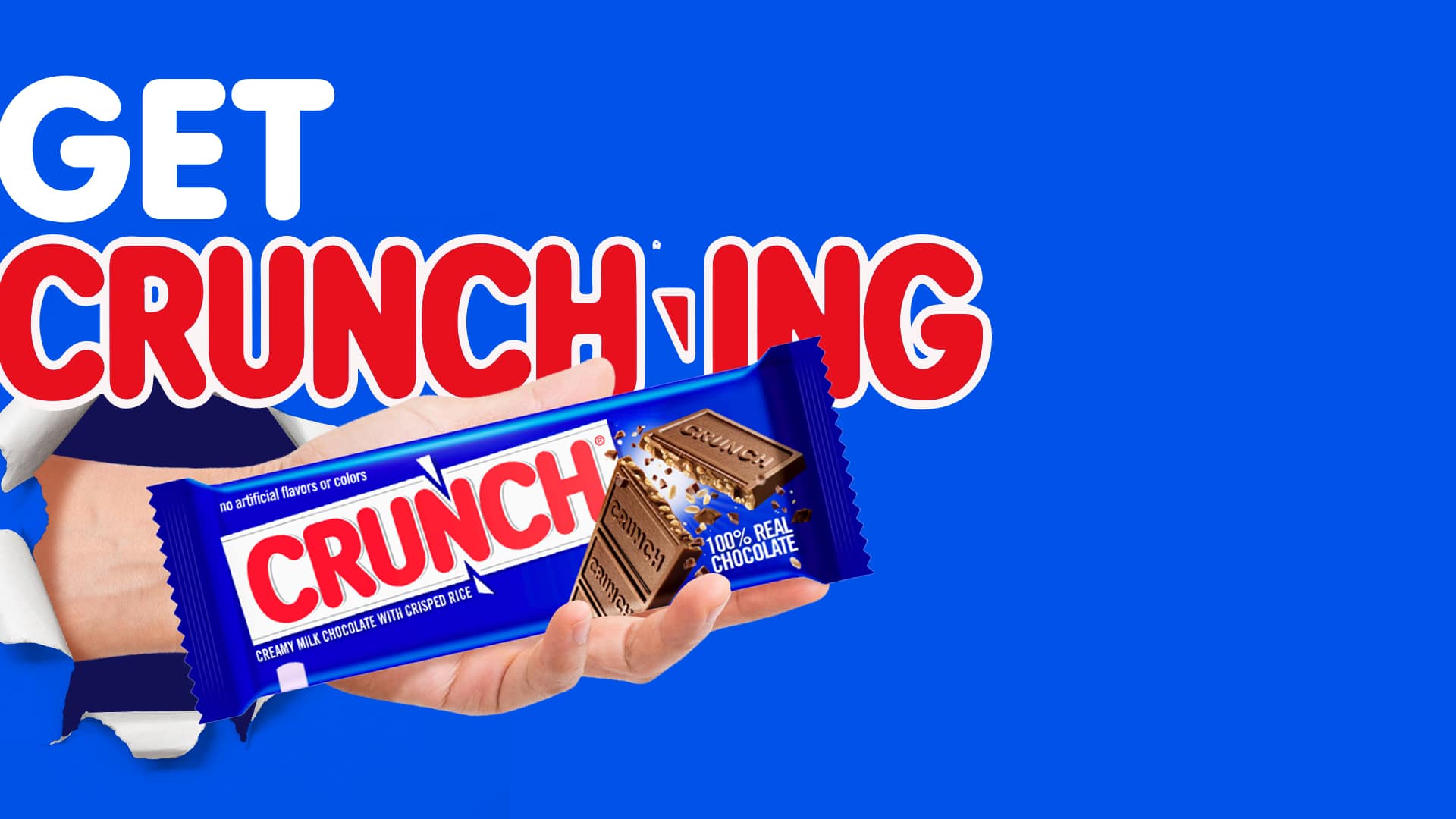 crunch bar in a hand exploding through the screen