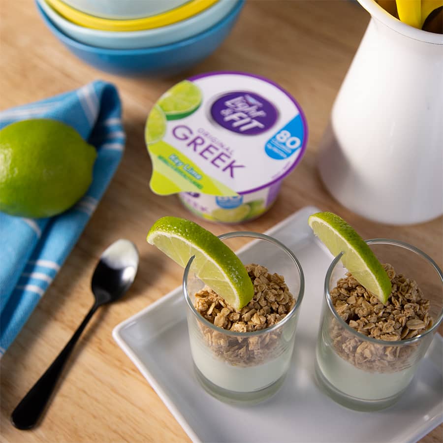 Light and Fit Greek yogurt parfaits garnished with granola and lime