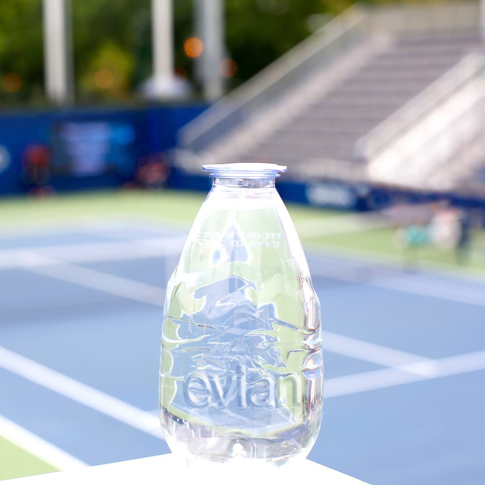 evian drop with tennis court in the background