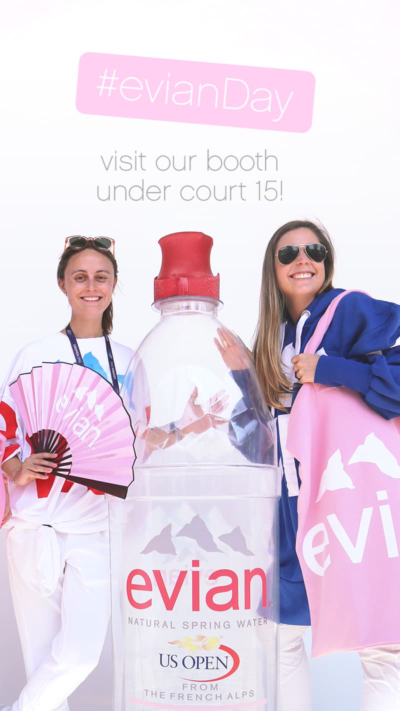 two women with oversized evian bottle and bag
